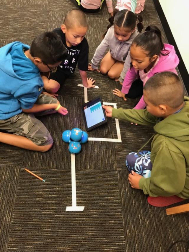 Scholars learn how to code robotics movements.