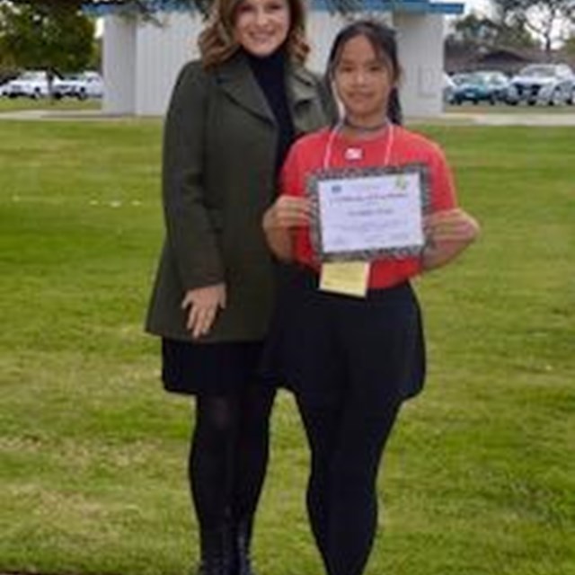 Principal Pinchot poses with our spelling bee champion.